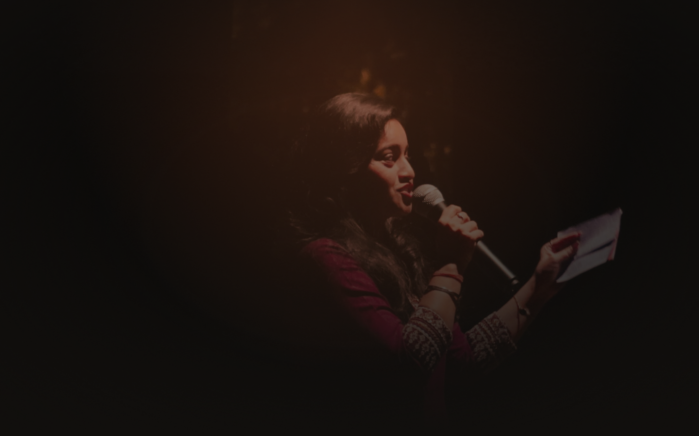 Aarzoo Jain hosting with a microphone